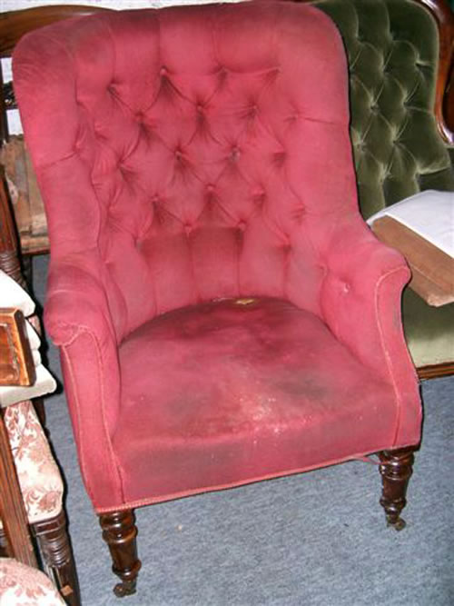 SOLD - An elegant 19th century buttoned back library chair with turned mahogany legs