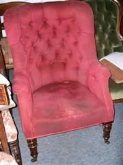 An elegant 19th century buttoned back library chair with turned mahogany legs