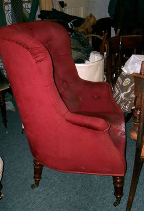 SOLD - An elegant 19th century buttoned back library chair with turned mahogany legs
