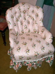 A late Victorian buttoned back tub chair